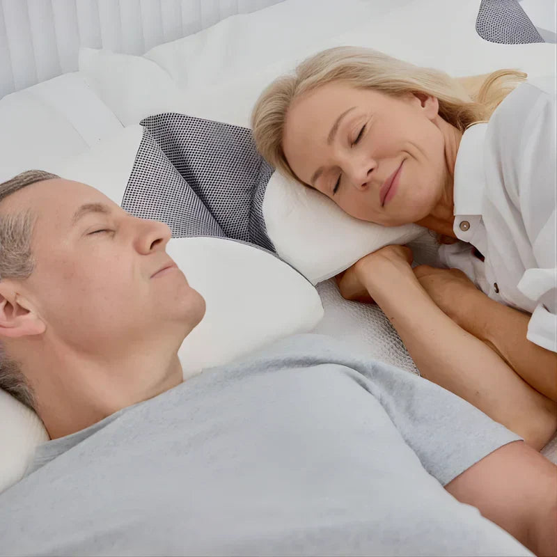 Couple sleeping on white ergonomic pillows for neck support and deep sleep.